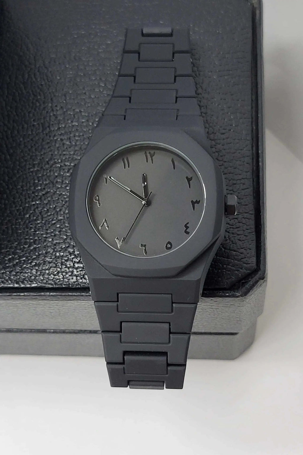 Close-up view of Arabic Aura Black Watch with sleek matte dial finishing and scratch-resistant glass.