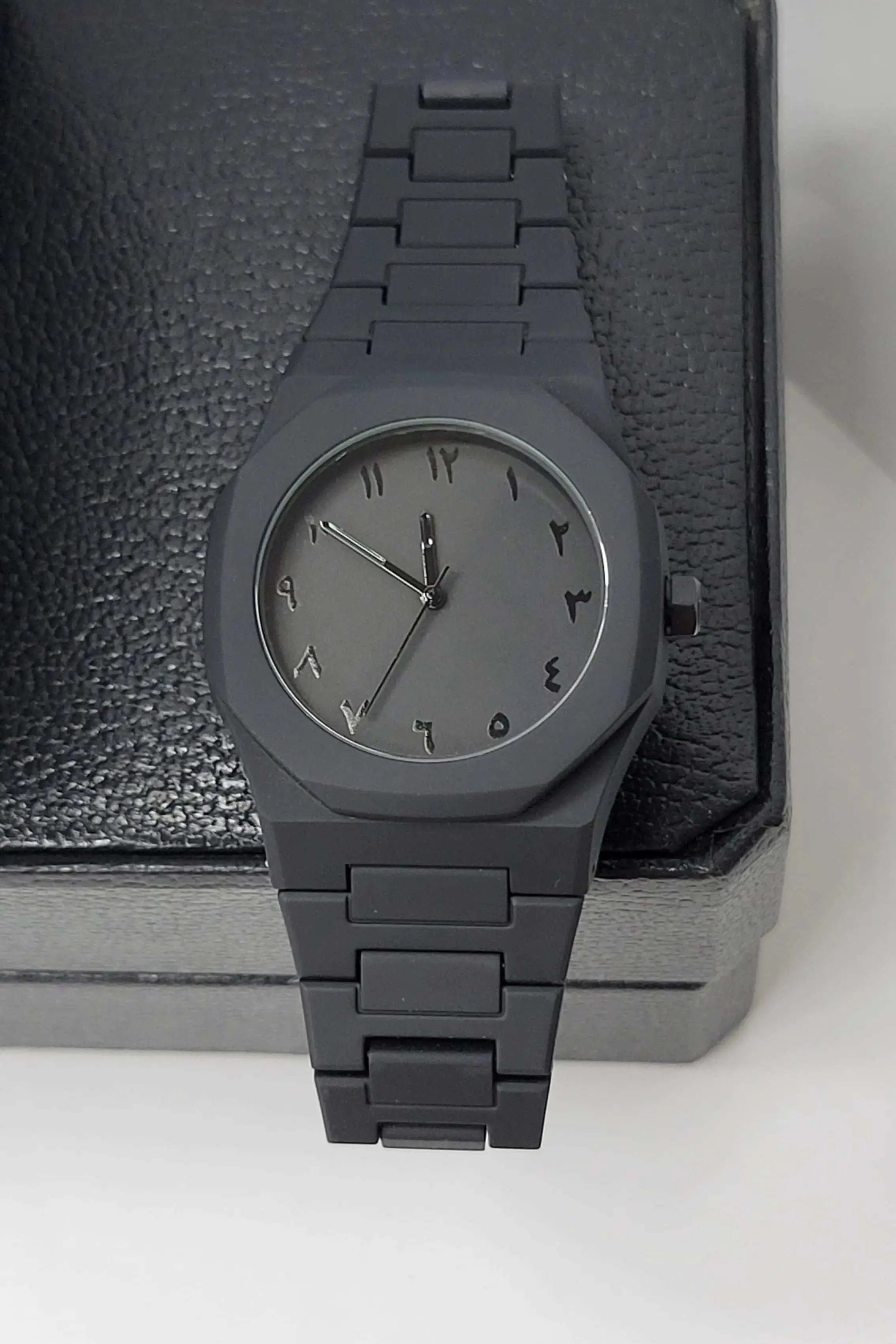 Close-up view of Arabic Aura Black Watch with sleek matte dial finishing and scratch-resistant glass.