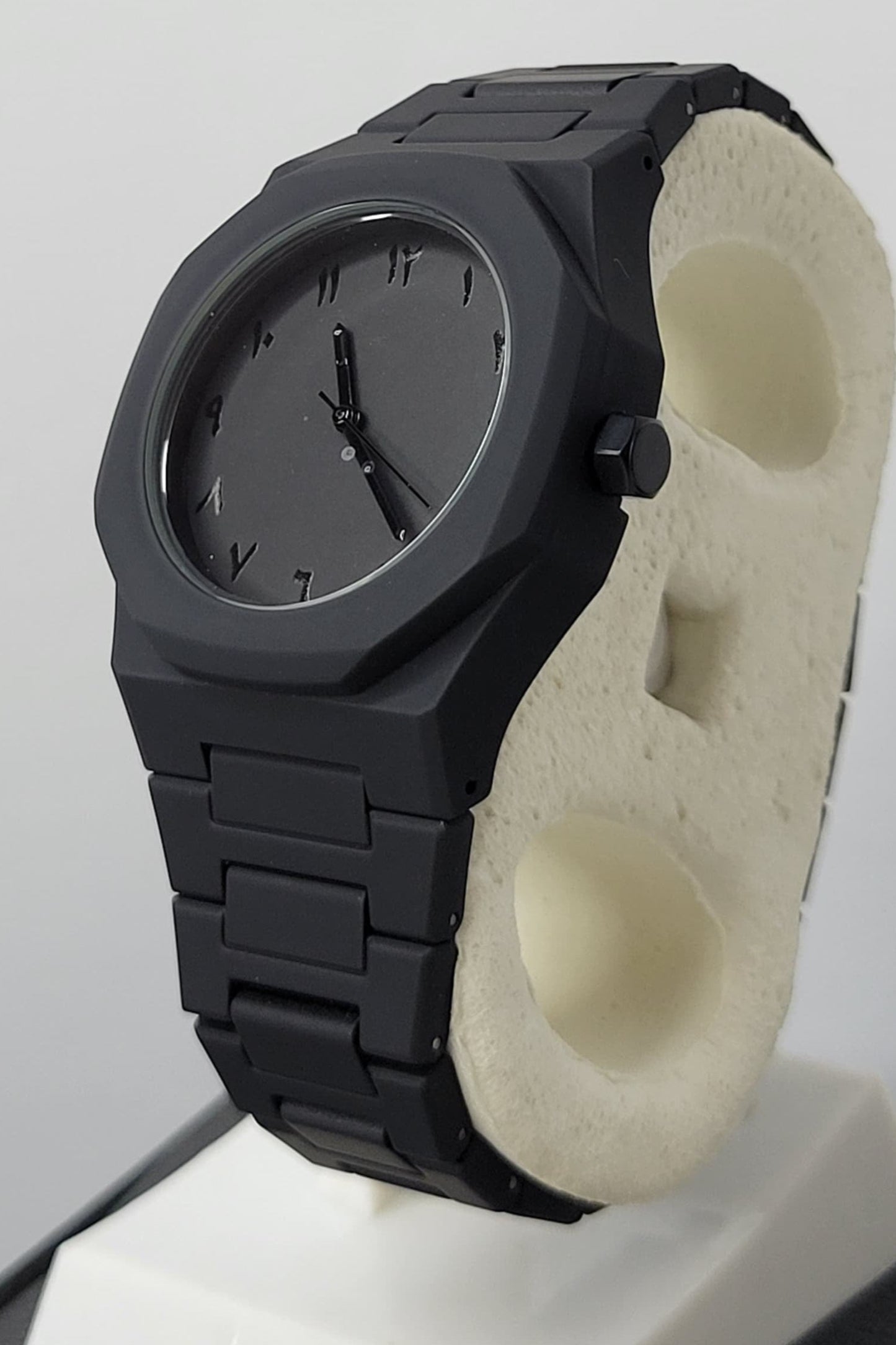 Side profile of Arabic Aura Black Watch showing carbon fiber strap and water-resistant case.