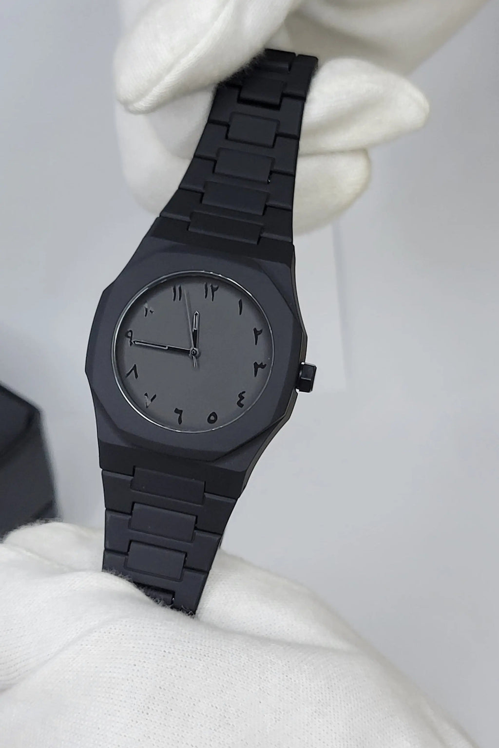 Side profile of Arabic Aura Black Watch showing carbon fiber strap and water-resistant case